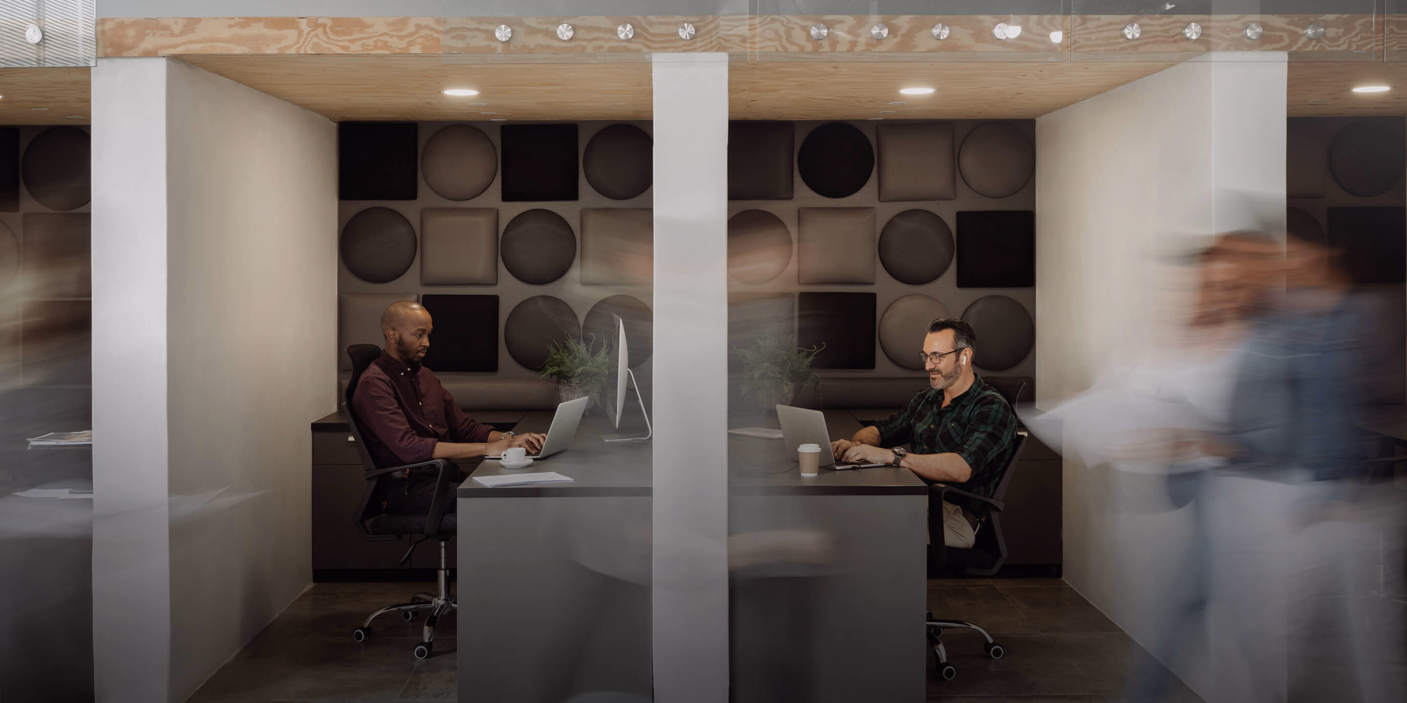 Two professionals shaking hands in an office building